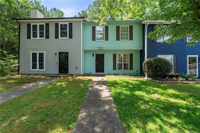 732 Jamestown Xing, Jonesboro, GA 30238 - view of front of home featuring a chimney and a front lawn