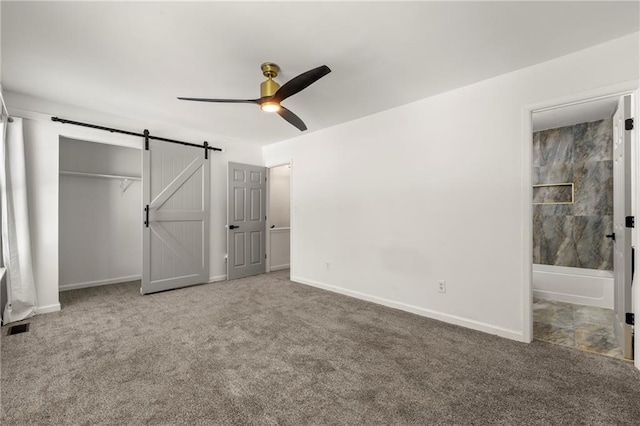732 Jamestown Xing, Jonesboro, GA 30238 - unfurnished bedroom with a barn door, carpet flooring, a closet, and ensuite bath