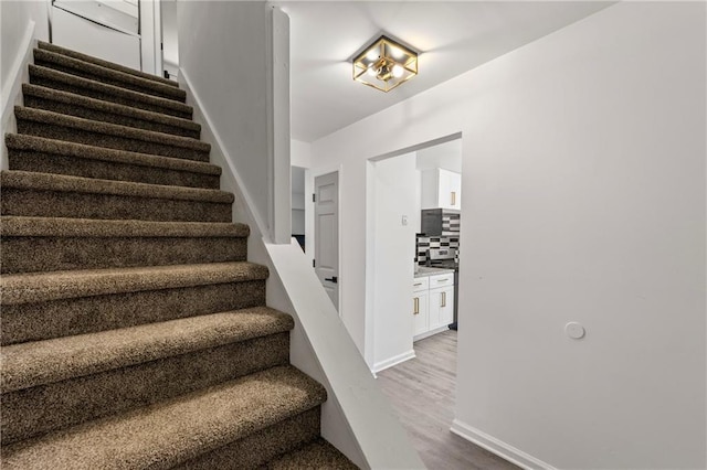 732 Jamestown Xing, Jonesboro, GA 30238 - stairway featuring wood finished floors and baseboards