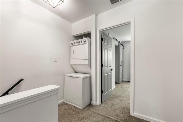 732 Jamestown Xing, Jonesboro, GA 30238 - laundry room featuring estacked washer and dryer, light colored carpet, and a barn door