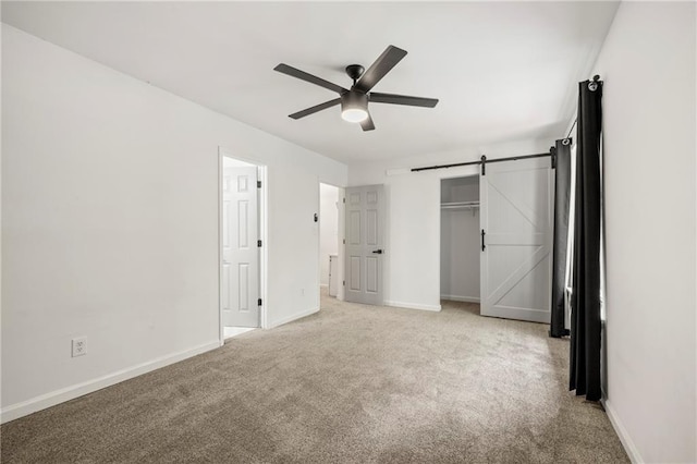 732 Jamestown Xing, Jonesboro, GA 30238 - unfurnished bedroom featuring light carpet, a barn door, ceiling fan, and a closet