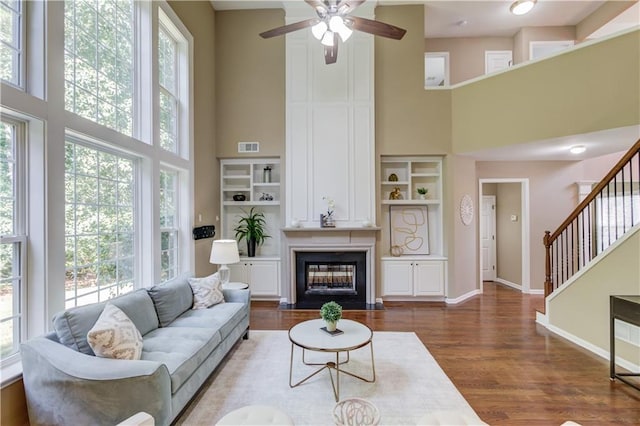 5115 Amberden Hall Dr, Suwanee, GA 30024 - living room with a high ceiling, a ceiling fan, dark wood-style flooring, baseboards, and stairs