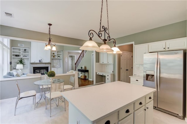 5115 Amberden Hall Dr, Suwanee, GA 30024 - kitchen featuring stainless steel fridge, light countertops, white cabinets, and a center island