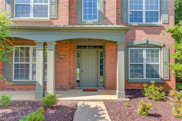 5115 Amberden Hall Dr, Suwanee, GA 30024 - view of exterior entry featuring brick siding and a porch
