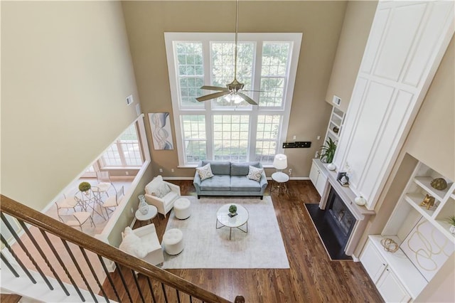 5115 Amberden Hall Dr, Suwanee, GA 30024 - living room featuring a high ceiling, dark wood finished floors, a ceiling fan, baseboards, and stairway