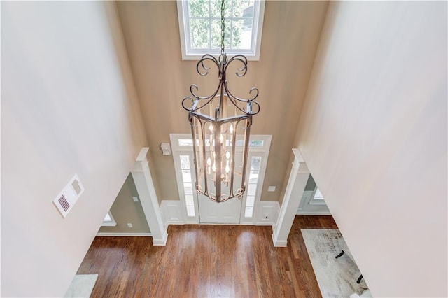 5115 Amberden Hall Dr, Suwanee, GA 30024 - foyer featuring a chandelier, wood finished floors, a towering ceiling, and wainscoting