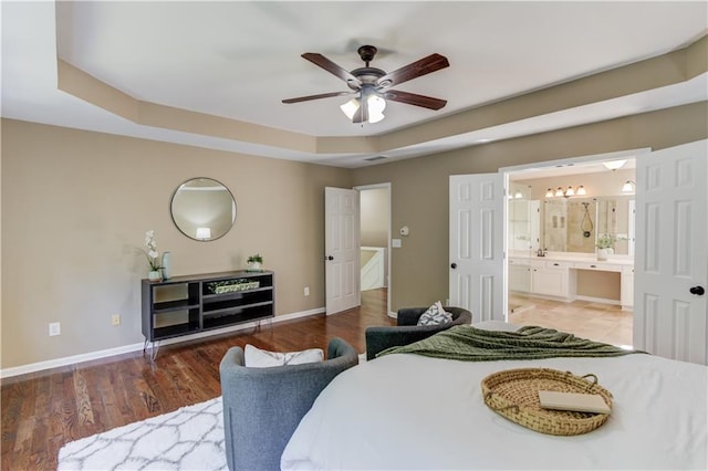 5115 Amberden Hall Dr, Suwanee, GA 30024 - bedroom with baseboards, a tray ceiling, ensuite bathroom, and wood finished floors