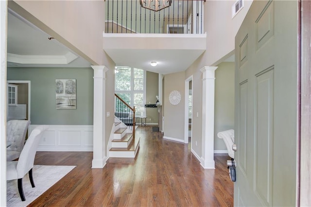 5115 Amberden Hall Dr, Suwanee, GA 30024 - entrance foyer with decorative columns, stairway, wood finished floors, a high ceiling, and a chandelier