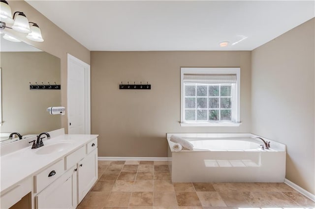 5115 Amberden Hall Dr, Suwanee, GA 30024 - full bathroom with vanity, baseboards, and a garden tub