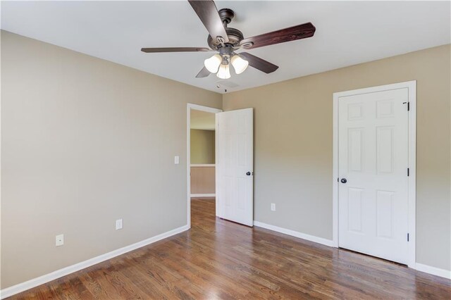 5115 Amberden Hall Dr, Suwanee, GA 30024 - unfurnished bedroom featuring baseboards, wood finished floors, and ceiling fan