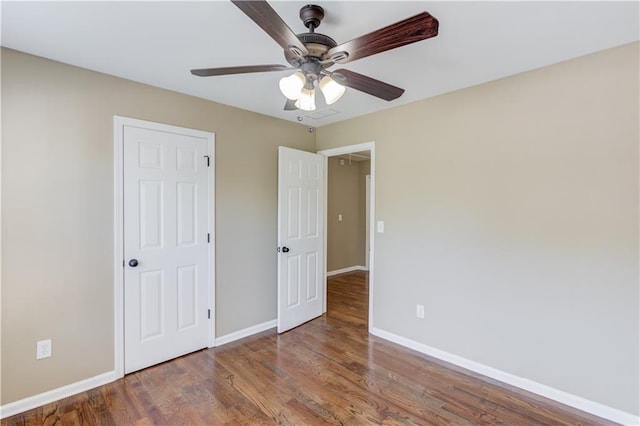 5115 Amberden Hall Dr, Suwanee, GA 30024 - unfurnished bedroom with baseboards, wood finished floors, and a ceiling fan