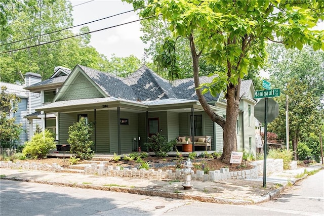 view of front facade featuring a porch and a shingled roof