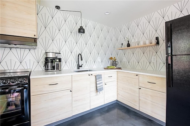 kitchen featuring open shelves, light brown cabinets, a sink, under cabinet range hood, and black appliances