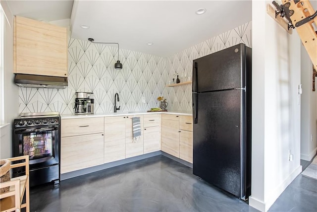 kitchen with light brown cabinets, modern cabinets, concrete floors, black appliances, and wallpapered walls