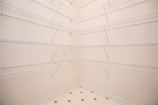 spacious closet with tile patterned floors