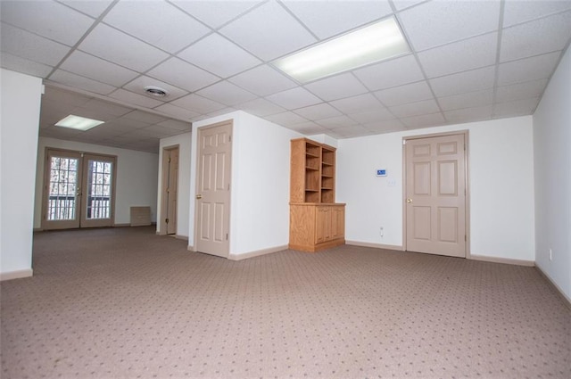 unfurnished room featuring french doors, visible vents, and baseboards