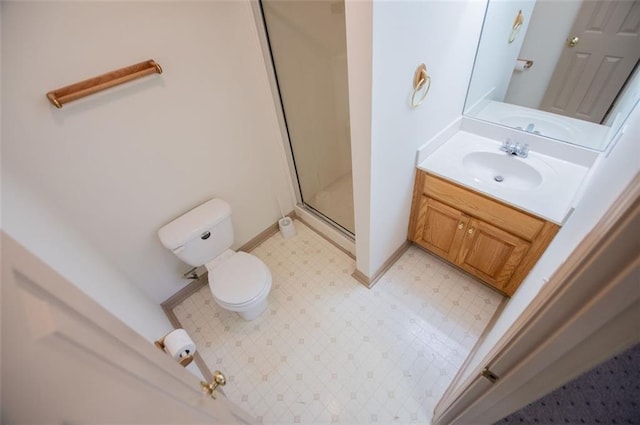 bathroom with baseboards, toilet, tile patterned floors, vanity, and a shower stall