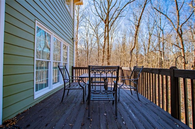 wooden terrace featuring outdoor dining space