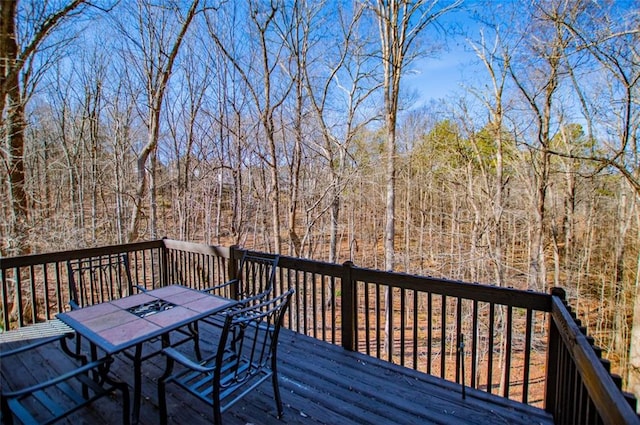 wooden terrace featuring outdoor dining space