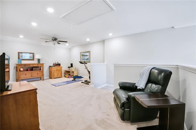 living area with ceiling fan and light colored carpet