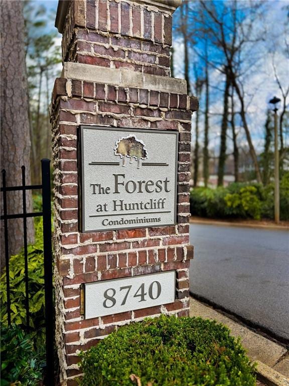 community sign featuring fence