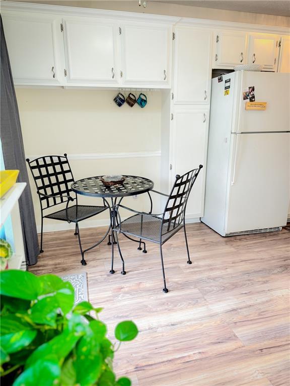 dining space with light wood finished floors