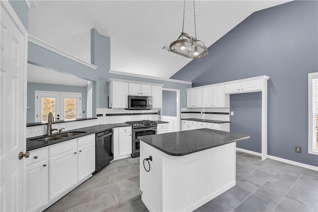 kitchen with appliances with stainless steel finishes, sink, white cabinets, decorative backsplash, and kitchen peninsula