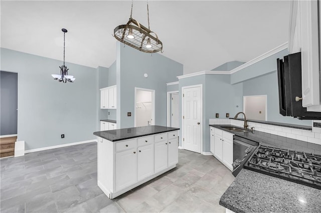 kitchen with dishwashing machine, sink, white cabinetry, hanging light fixtures, and a kitchen island