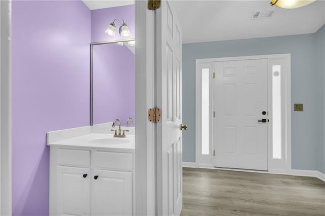 bathroom with hardwood / wood-style flooring and vanity