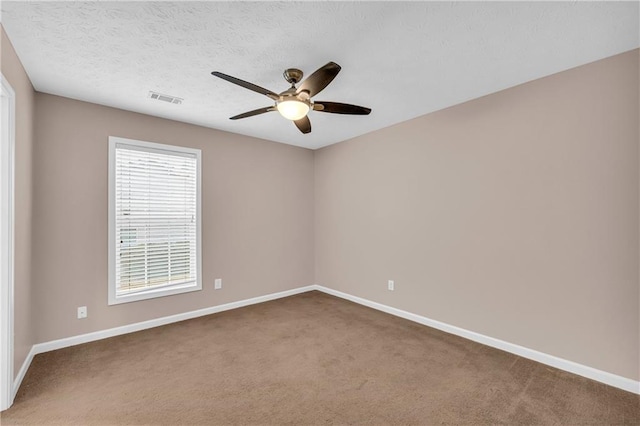 spare room with carpet floors and ceiling fan