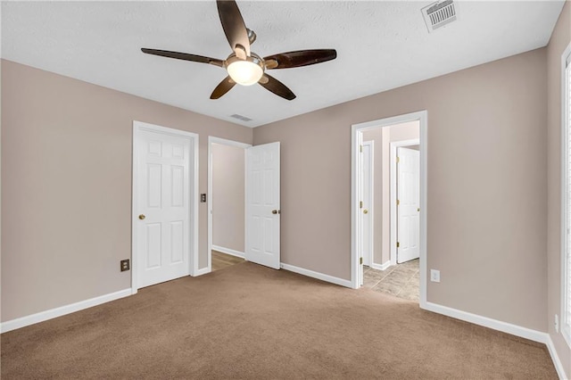 unfurnished bedroom with light colored carpet and ceiling fan