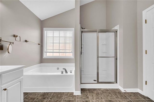 bathroom with lofted ceiling, independent shower and bath, and vanity