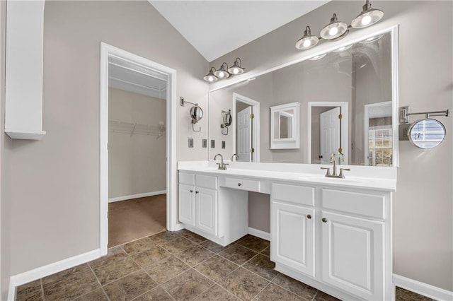 bathroom featuring lofted ceiling and vanity