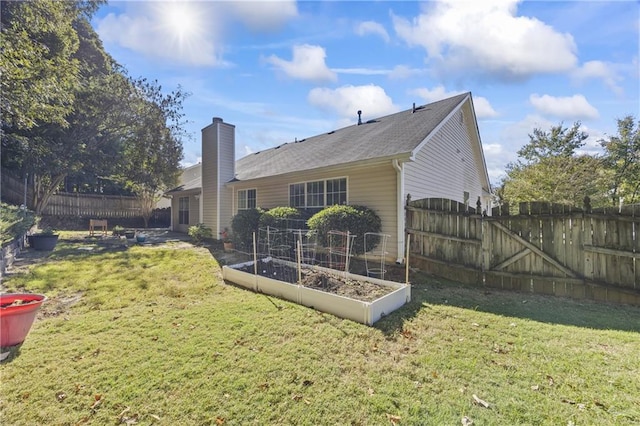 back of house with a lawn