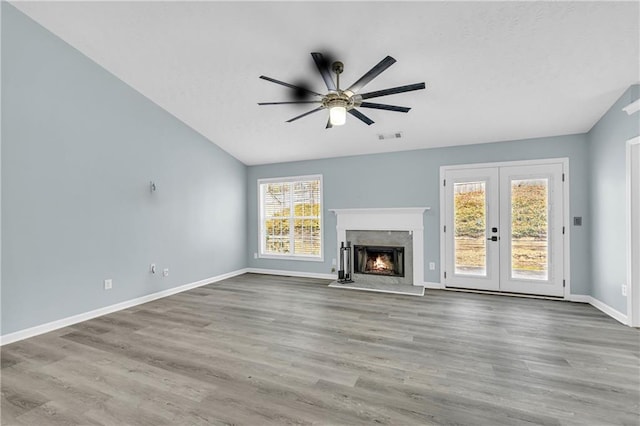 unfurnished living room with hardwood / wood-style floors and vaulted ceiling