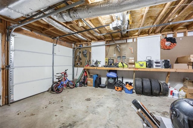 garage with a garage door opener and a workshop area