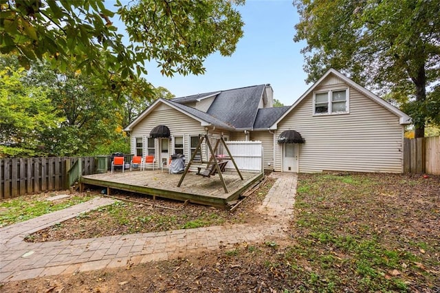 rear view of property with a wooden deck