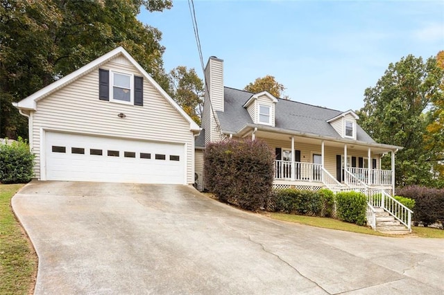 new england style home with covered porch and a garage