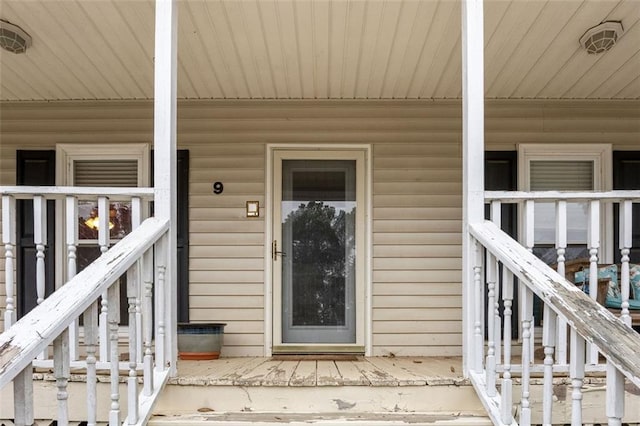 view of exterior entry with covered porch