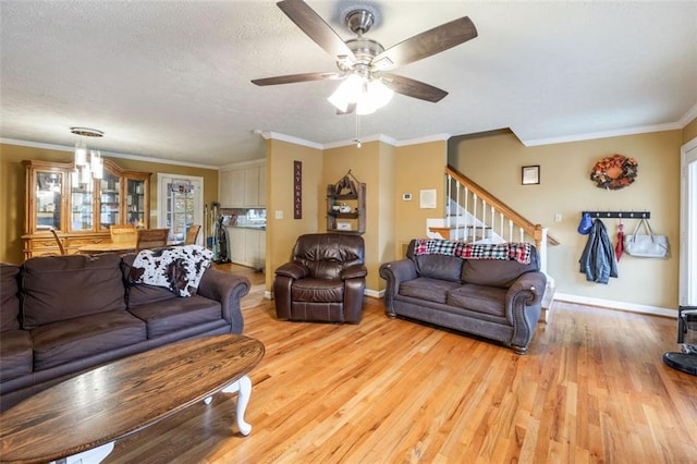 living room featuring light hardwood / wood-style flooring, ornamental molding, a healthy amount of sunlight, and ceiling fan