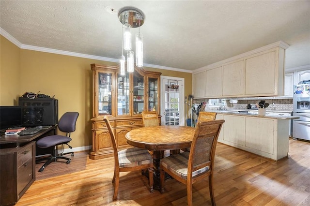 dining space with crown molding and light hardwood / wood-style floors