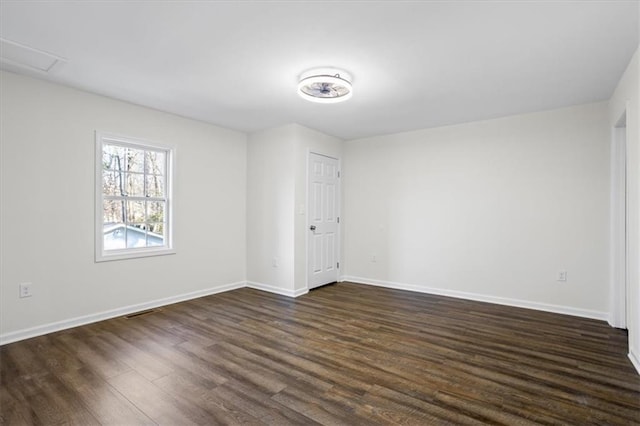 spare room featuring dark hardwood / wood-style floors