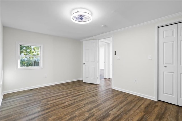 unfurnished bedroom featuring a closet and dark hardwood / wood-style floors