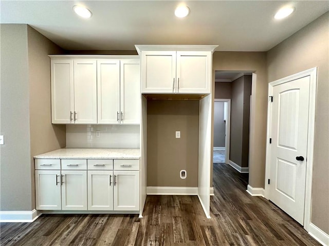 kitchen featuring dark wood-style flooring, white cabinets, and baseboards