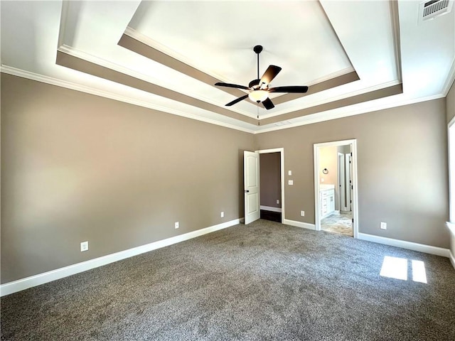 unfurnished bedroom with crown molding, a raised ceiling, visible vents, and baseboards