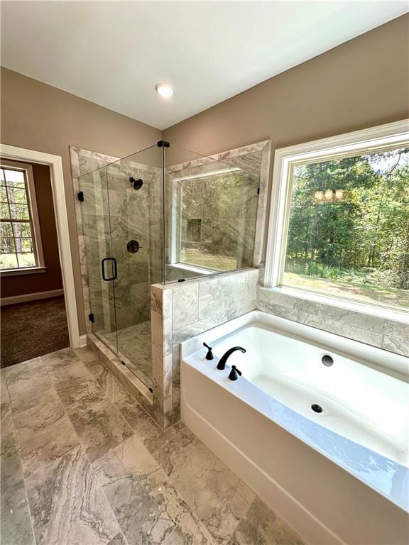 full bathroom featuring a shower stall and a bath