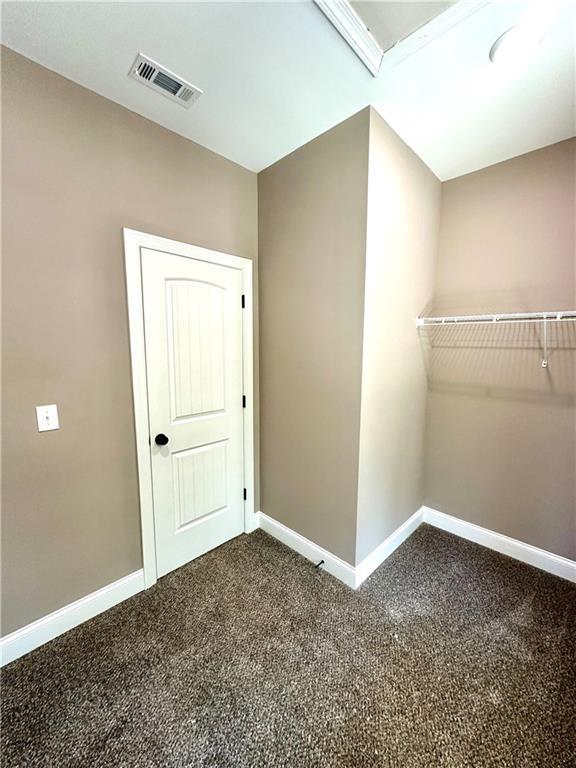 interior space featuring carpet flooring, visible vents, and baseboards