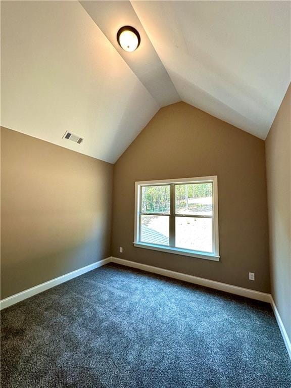 additional living space featuring lofted ceiling, carpet, baseboards, and visible vents