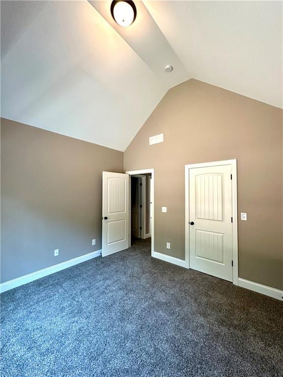 interior space featuring baseboards, vaulted ceiling, and carpet flooring