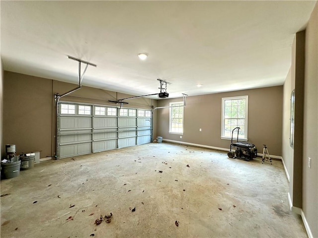 garage featuring a garage door opener and baseboards